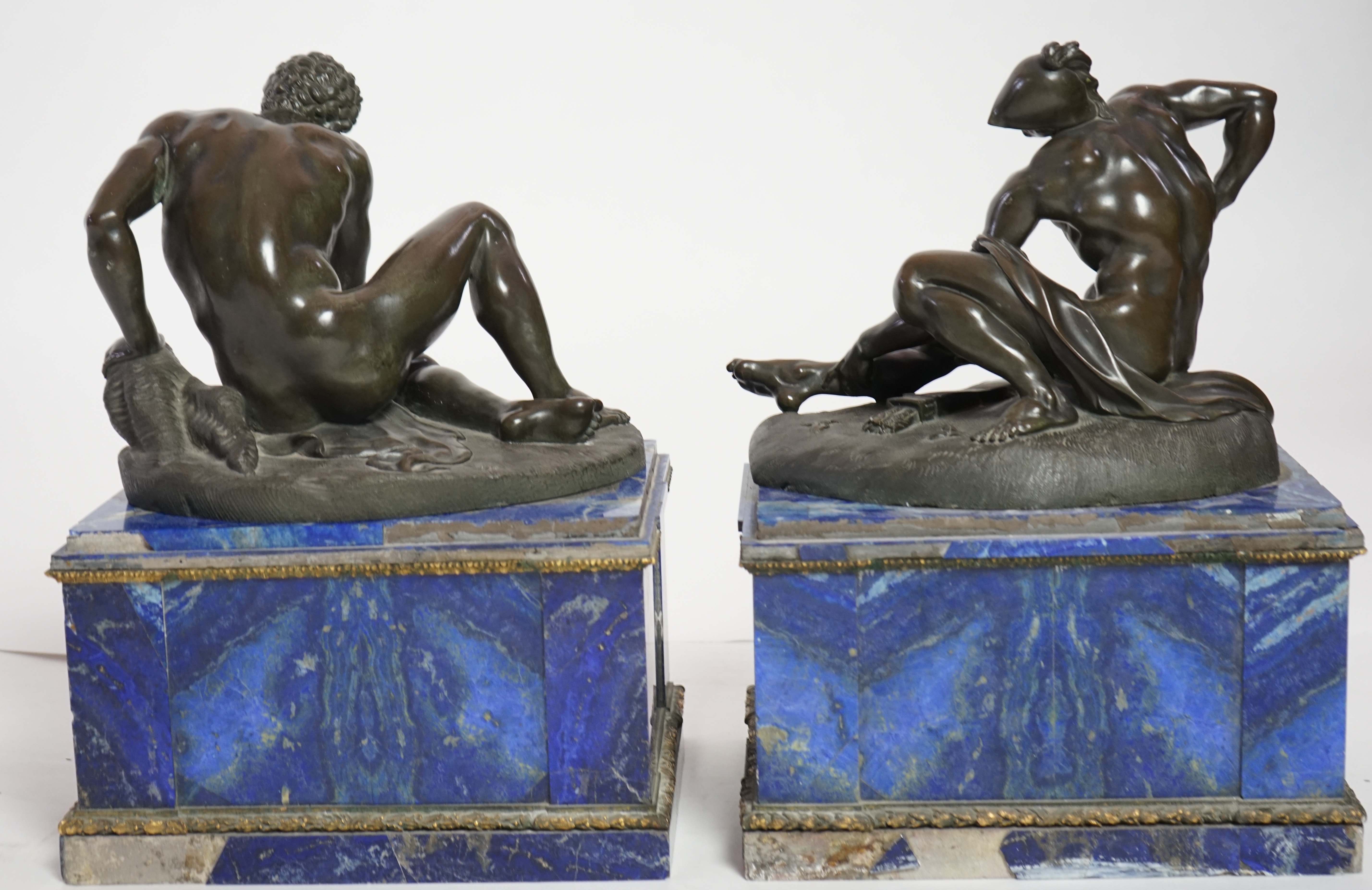 After the antique, a pair of late 18th/early 19th century Grand Tour souvenir bronze figures of seated warriors